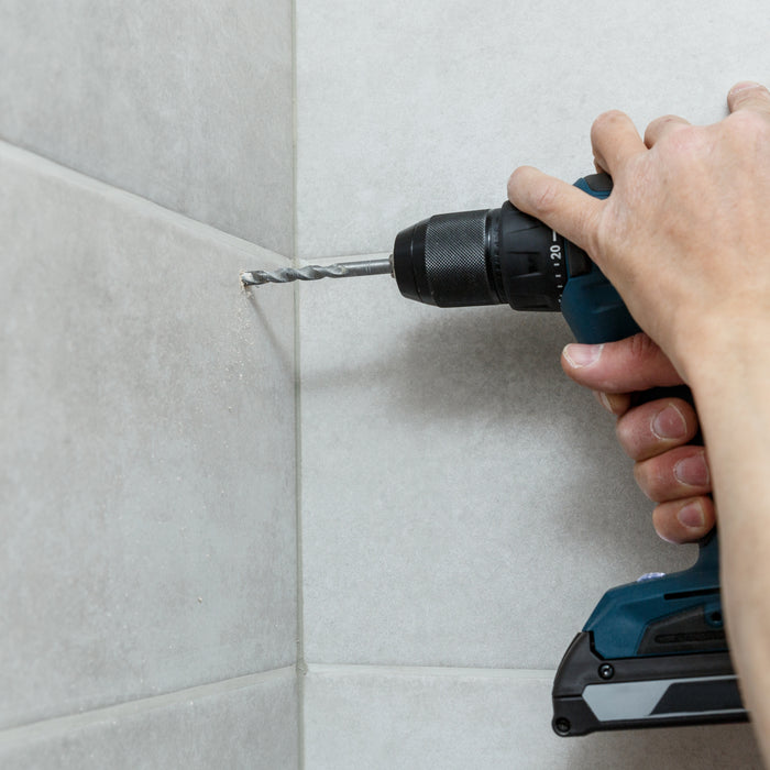How do I drill through ceramic and porcelain tile?